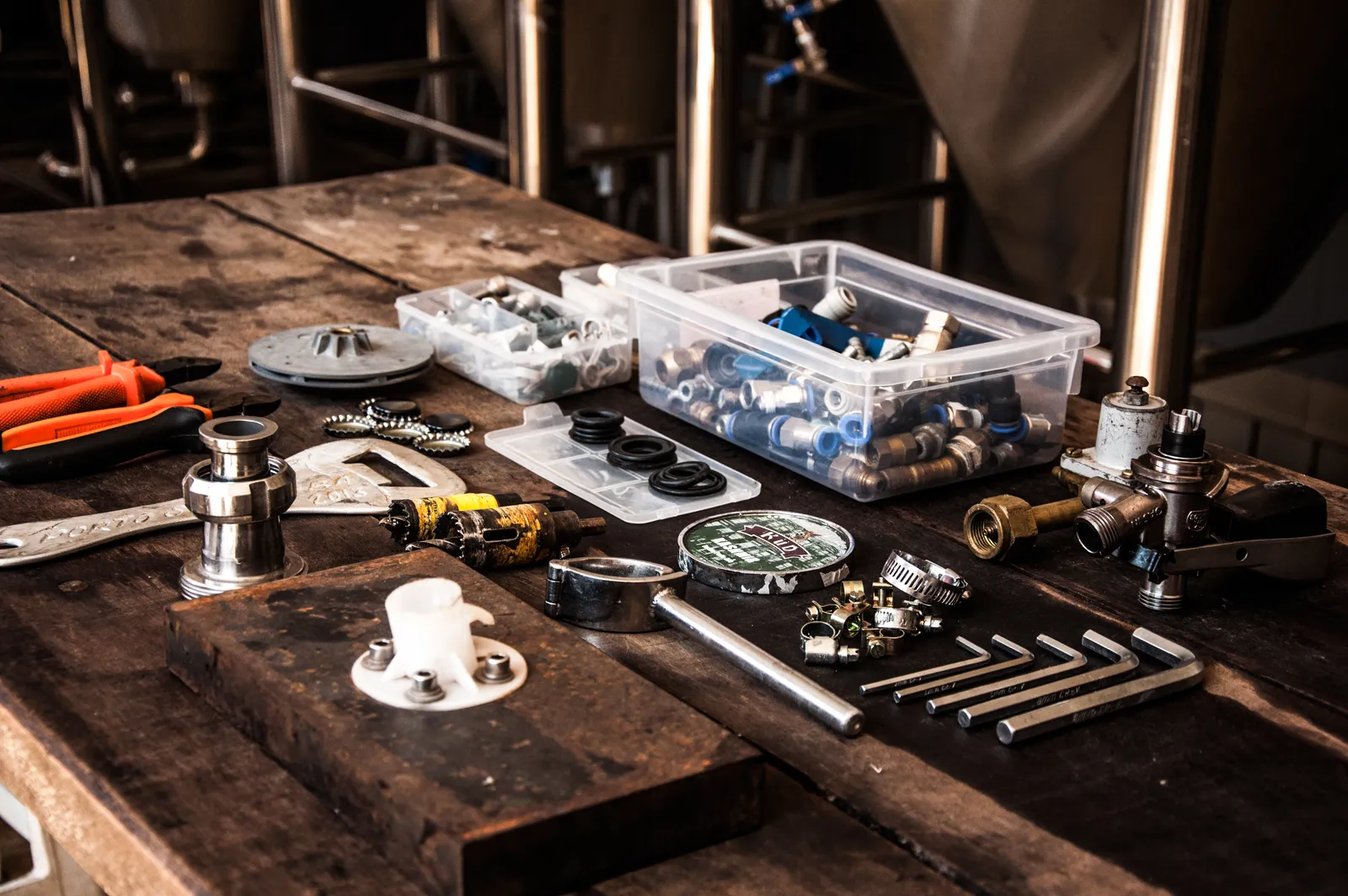 Pipe fittings, clamps, and repair tools on a workbench