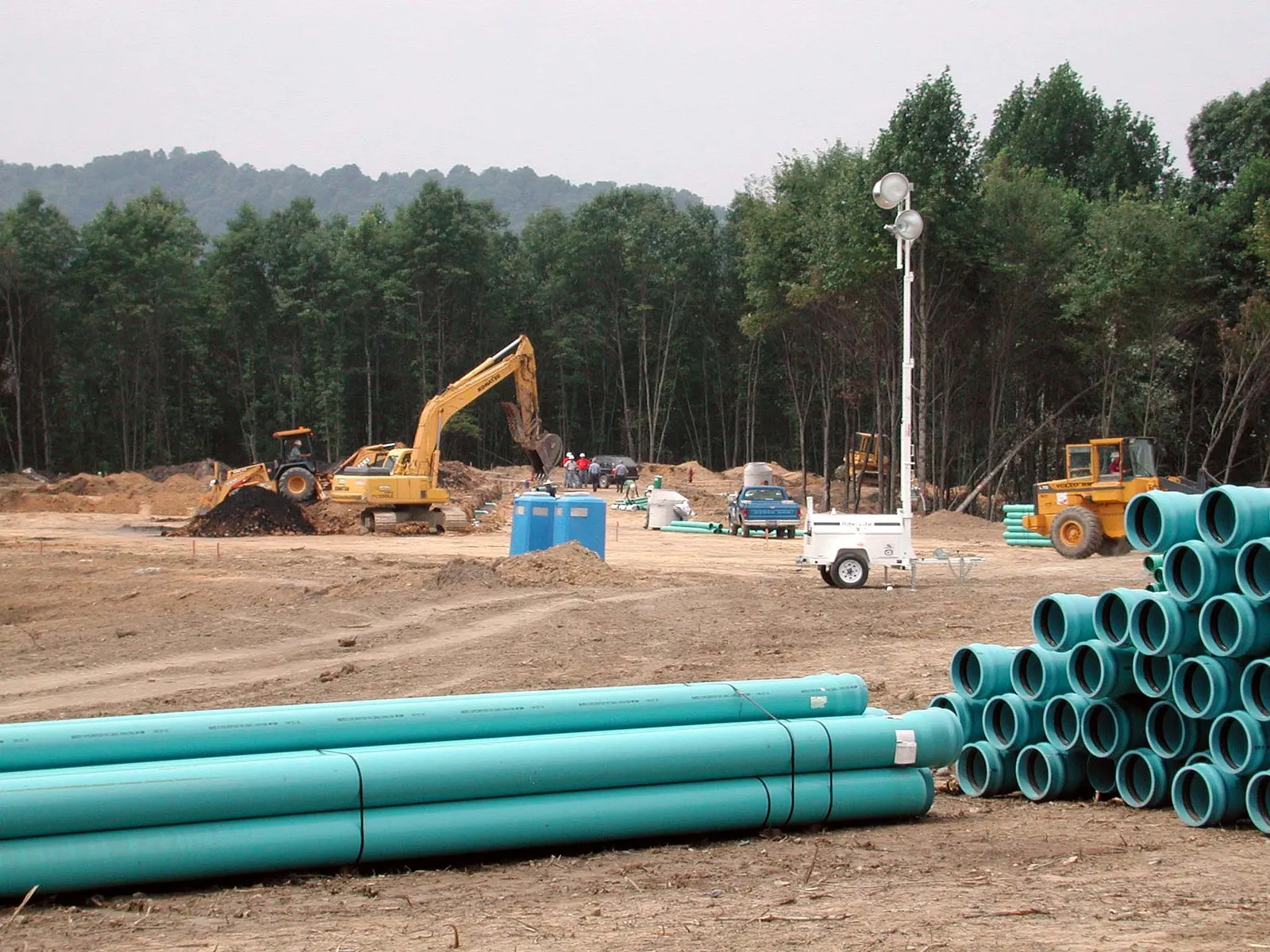 New sewer pipe sections staged at a work site